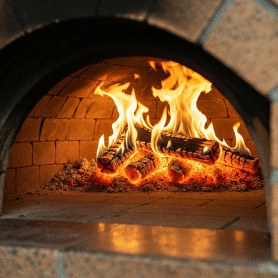 Interior of a traditional wood-fired pizza oven with glowing embers and flames